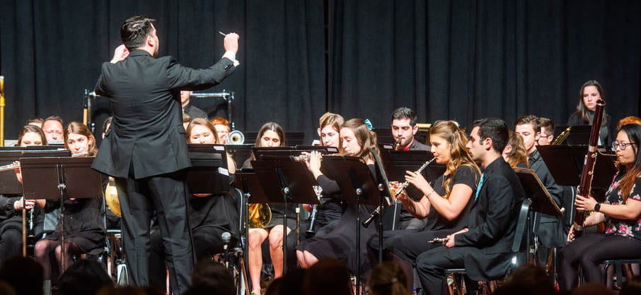 Photo of Eric Melley conducting Symphonic Winds in Spring 2019